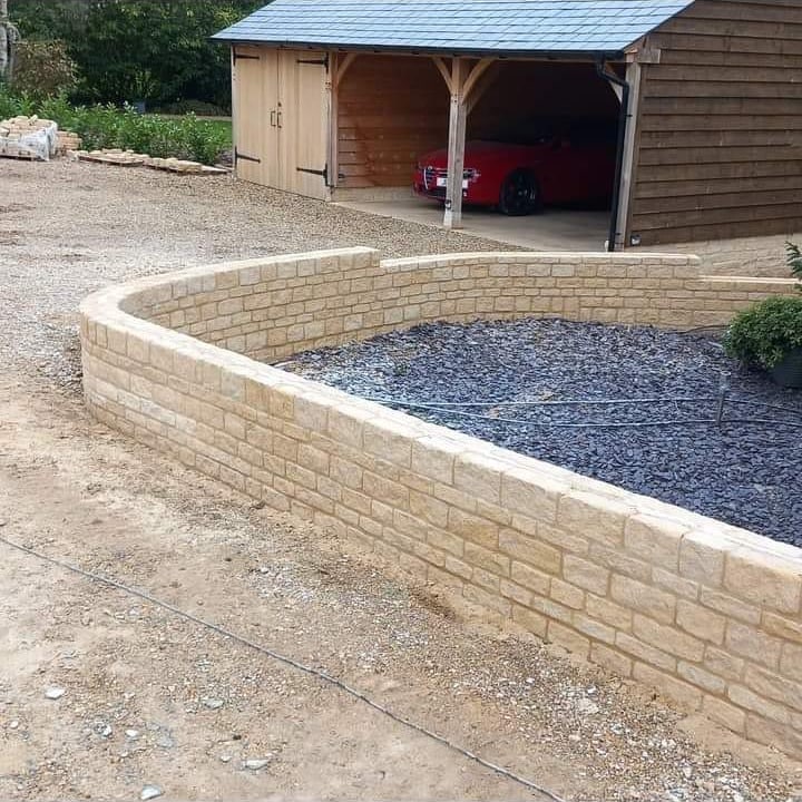 Stone front entrance with oak porch by Advanced Builders